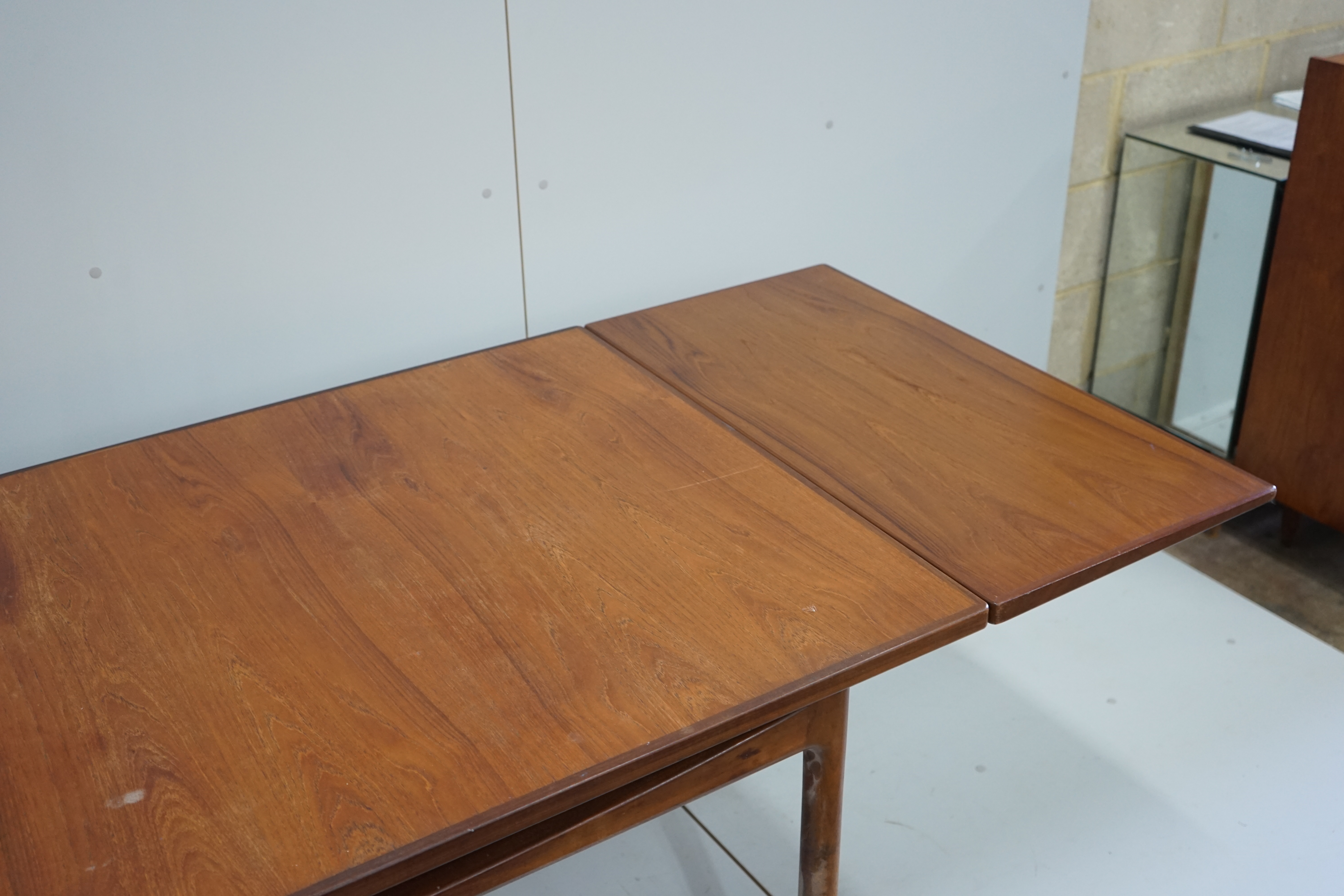 Henning Kjaernulf for Bruno Hansen, four Model 225 'Wishbone' teak dining chairs, width 55cm, depth 44cm, height 64cm and a rectangular extending teak dining table, 244cm extended, width 89cm, height 72cm